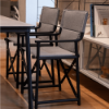 Boss sling folding chairs with gray fabric and black frames arranged around a commercial dining table indoors