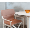 Boss sling folding chair with amber fabric and ivory polypropylene frame paired with a café table in a modern seating setting