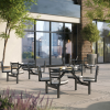 outdoor fiberglass cluster tables with attached seats arranged on patio outside café for commercial dining use