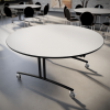 60 inch round folding tables arranged in cafeteria with open seating layout and mobile bases for flexibility