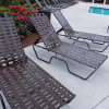 Sundance cross-weave commercial chaise lounges arranged around an outdoor swimming pool with adjustable backrests