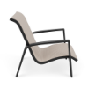 Side view of Skyline commercial sand chair with Cane Oyster sling fabric, Starlight Black aluminum frame, and integrated armrests