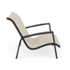 Side view of Skyline commercial sand chair with Cane Oyster padded sling fabric, Starlight Black aluminum frame, and integrated armrests