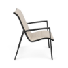 Side view of Skyline padded sling dining chair with Cane Oyster fabric, Starlight Black aluminum frame, and streamlined armrests