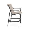 Side view of Skyline commercial bar chair with Cane Oyster sling fabric, Starlight Black aluminum frame, armrests, and footrest