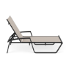 Side view of Skyline commercial chaise lounge with Cane Oyster sling fabric, Starlight Black frame, Black MGP armrests, and reclining backrest