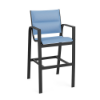 Three-quarter front view of a commercial outdoor bar height stool with a black powder-coated frame and padded light blue sling fabric.