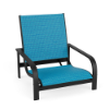 Three-quarter front view of a low-profile commercial outdoor sand chair featuring a dark textured charcoal aluminum frame and bright blue sling seating.