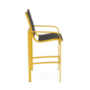 Side profile view of a tall patio bar stool with a bright yellow metal frame, lower footrest support, and dark metallic gray sling seating.