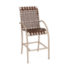 Three-quarter front view of a commercial outdoor bar chair with a textured antique beige frame, integrated foot bracing, and rich Saddle brown cross-weave strap seating.