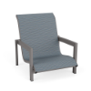 Three-quarter front view of a low-to-the-ground commercial outdoor sand lounge chair with a Titanium Gray metallic frame and a textured slate blue Kozo Jewel sling.