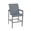Three-quarter front view of a high-top commercial outdoor bar chair with armrests, a Titanium Gray metallic frame, and a slate blue Kozo Jewel textured sling.
