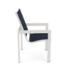 Side profile view of a commercial outdoor dining arm chair featuring a powder-coated Sky White aluminum frame and a dark navy blue Dupione Sapphire double sling fabric seat and backrest.