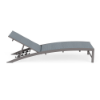 Side profile view of a commercial outdoor padded sling chaise lounge with an arched aluminum frame in Titanium Gray, adjustable reclining backrest, and a slate blue Kozo Jewel cushioned sling.