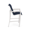 Side profile view of an elevated commercial outdoor bar chair featuring a crisp Sky White aluminum frame, footrest rung, and a dark navy blue Dupione Sapphire padded sling seat.