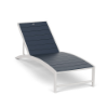 Front three-quarter view of a commercial poolside chaise lounge featuring a Sky White aluminum frame and dark navy blue Dupione Sapphire Marine Grade Polymer (MGP) slatted surface.