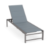 Front three-quarter view of an outdoor commercial chaise lounge constructed with a Titanium Gray frame and a slate blue Kozo Jewel padded sling surface.