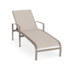 Front three-quarter perspective view of a commercial outdoor chaise lounge featuring integrated armrests, a warm beige Satin Amber aluminum frame, and a neutral beige Cane Oyster sling seat bed.