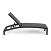 A side profile view of an adjustable commercial chaise lounge featuring a dark Textured Charcoal powder-coated frame paired with neutral Susquehanna Grey Marine Grade Polymer (MGP) slats.
