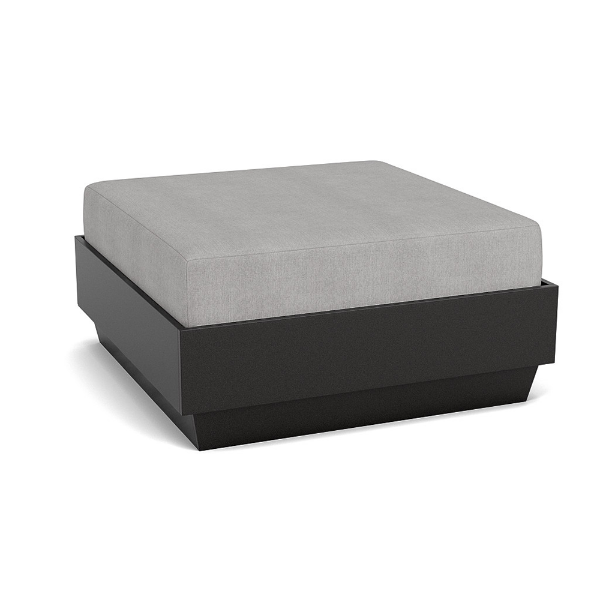 A front three-quarter view studio product shot of a square commercial outdoor ottoman featuring a dark Black Granite Marine Grade Polymer (MGP) platform base topped with a thick light gray upholstered cushion.