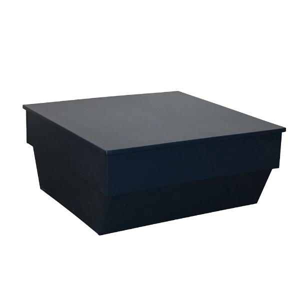 A front three-quarter view studio product shot of a square modern commercial outdoor coffee table constructed entirely from solid black Marine Grade Polymer (MGP) with a smooth tabletop and tiered pedestal platform base.