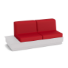 A front three-quarter view studio product shot of a commercial outdoor sofa featuring a White Marine Grade Polymer (MGP) platform base with a built-in side table surface on the left side and bold Logo Red upholstered cushions.