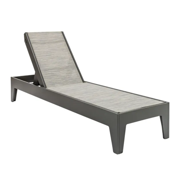 Front three-quarter view of a flat Marine Grade Polymer chaise lounge featuring a dark grey Fossil Grey frame and a light grey textured Kozo sling fabric seat.