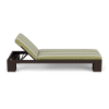 Side profile view of an adjustable commercial outdoor poolside chaise lounge featuring a woven chocolate wicker frame and a green and white patterned fabric cushion