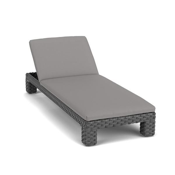 Three-quarter front view of a commercial outdoor adjustable chaise lounge with a thick woven gray synthetic wicker frame and a matching solid charcoal gray full-length cushion.