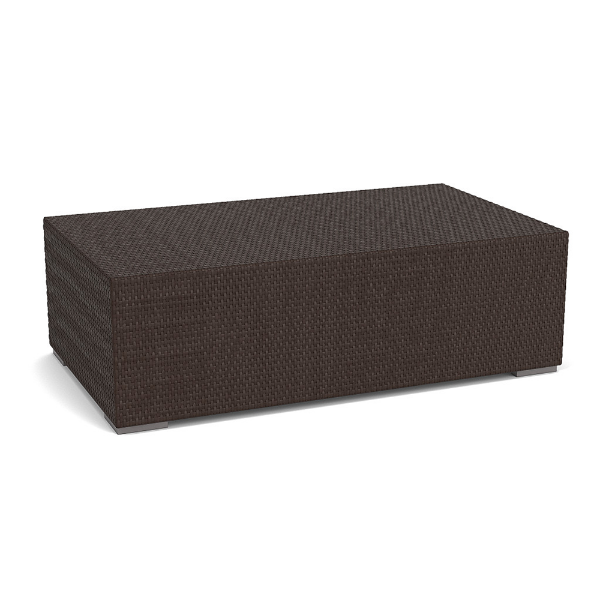 Three-quarter perspective view of a low rectangular commercial outdoor coffee table completely wrapped in dark brown synthetic wicker with small block feet.