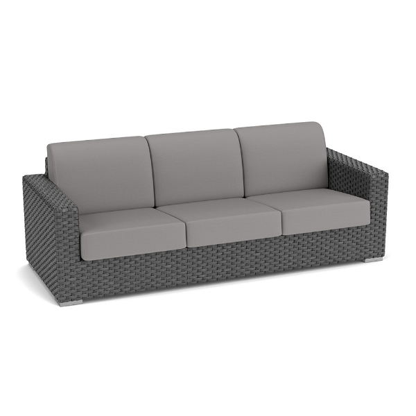 Three-quarter perspective view of a three-seat commercial outdoor sofa constructed from dark gray Highland resin wicker, featuring medium gray seat and back cushions.
