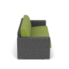 Side profile view of a dark gray woven resin wicker commercial outdoor sofa fitted with bright macaw green seat and back cushions.