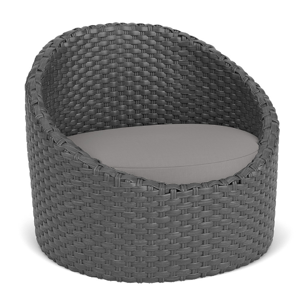 Three-quarter perspective view of a rounded commercial outdoor barrel chair woven from dark gray Highland resin wicker, fitted with a medium gray seat cushion.