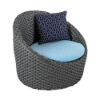 High-angle perspective view of a dark gray resin wicker outdoor barrel chair featuring a sky blue seat cushion and a dark blue patterned geometric accent pillow.