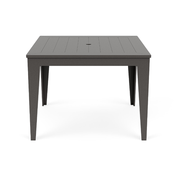 Straight-on front view of a 42-inch square MGP outdoor dining-height table featuring a uniform dark grey finish on both the slatted top (with a centered umbrella hole) and the tapered legs