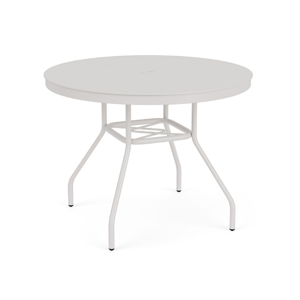 Eye-level perspective view of a 36-inch round Sundance commercial aluminum dining table finished in Sky White powder coat, showcasing a smooth solid aluminum tabletop, splayed legs, lower umbrella bracing, and a center umbrella hole.