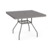 Eye-level perspective view of a 36-inch square Sundance commercial aluminum outdoor dining table finished in Titanium Gray, featuring a square table surface perforated in a uniform square grid cube pattern and lower umbrella support bracing.