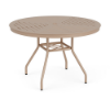 Three-quarter perspective view of a 42-inch round Sundance commercial aluminum outdoor dining table in Textured Antique Beige, featuring curved aluminum legs, lower umbrella bracing, and a slotted slat tabletop pattern with a center umbrella hole.