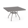 Three-quarter perspective view of a 42-inch square Sundance commercial outdoor dining table in Titanium Gray finish, featuring splayed legs, lower umbrella bracing, and an aluminum top perforated with a square cube grid pattern and middle umbrella opening.