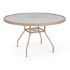 Three-quarter perspective view of a 48-inch round Sundance commercial outdoor dining table with a textured acrylic top and a Textured Antique Beige aluminum frame, showing splayed legs, lower umbrella bracing, and a middle umbrella ring.