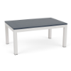 A rectangular outdoor coffee table with a dark navy blue MGP slatted top mounted on a bright white aluminum frame and four straight legs.