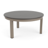 A round patio coffee table with a smooth grey slatted MGP tabletop and a satin amber beige aluminum frame with four straight legs