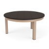 A round commercial patio coffee table with a dark Northeastern Walnut wood-grain MGP top mounted on a textured antique beige aluminum base.
