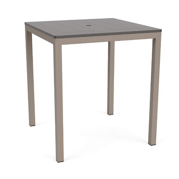 A square outdoor bar-height patio table featuring a smooth grey slatted MGP top with a center umbrella hole, supported by a Satin Amber beige aluminum frame.