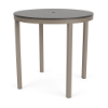 A round bar-height outdoor patio table with a smooth grey slatted MGP tabletop and umbrella hole, supported by a Satin Amber beige aluminum base
