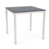 A square commercial outdoor bar table with a dark navy blue MGP slatted top featuring a center umbrella hole, set on a tall Sky White aluminum base.