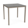 A 42-inch square bar-height patio table featuring a neutral grey slatted MGP tabletop with an umbrella hole, supported by a Satin Amber beige aluminum frame.