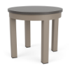 A 20-inch round commercial patio side table with a textured grey MGP top mounted on a Satin Amber beige-toned aluminum frame.