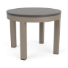 A 24-inch round outdoor side table featuring a smooth neutral grey MGP surface set in a warm beige-toned Satin Amber aluminum frame.