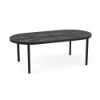 An oval-shaped commercial outdoor aluminum dining table in Starlight Black with a slotted/slat tabletop design and a center umbrella hole.